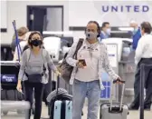  ?? AP FILE PHOTO ?? Passengers wearing face masks leave a United Airlines ticket counter on June 16 in Tampa. Airline travel is still down significan­tly, and United is considerin­g furloughin­g 36,000 employees.