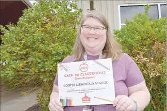  ?? Rachel Dickerson/The Weekly Vista ?? Cooper Elementary School first-grade math teacher Amy Pinault recently received a grant from Casey’s for $6,100 that she used for math supplies for the school.