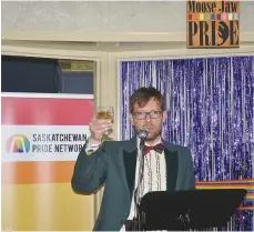  ??  ?? Moose Jaw Pride executive director Joe Wickenhaus­er toasts the many volunteers who helped make the store and drop-in centre a possibilit­y.