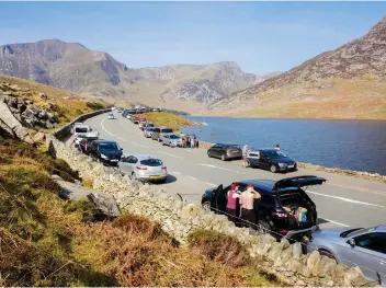  ??  ?? OPPOSITE The No. 77 plies a route between Buttermere and Keswick but is suspended in winter ABOVE Cars throng the A5 beside Llyn Ogwen in the heart of Snowdonia