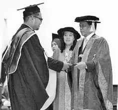  ??  ?? Shafie presenting the scroll to one of the graduates at UMS yesterday.