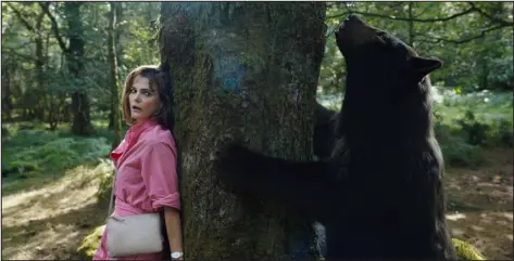  ?? PAT REDMOND — UNIVERSAL PICTURES ?? Keri Russell’s Sari tries to avoid detection by an aggressive bear in a scene from “Cocaine Bear.”