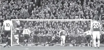  ??  ?? Arsenal’s Pierre-Emerick Aubameyang scores their first goal from the penalty spot. — Reuters photo