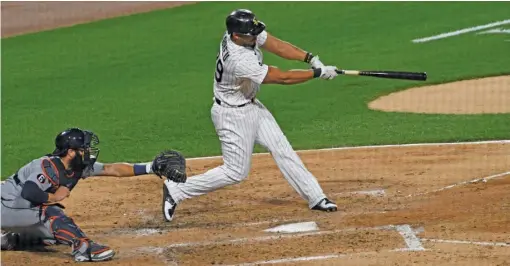  ?? DAVID BANKS/GETTY IMAGES ?? Sox first baseman Jose Abreu hits a two-run double during the fourth inning Tuesday against the Tigers at Guaranteed Rate Field.