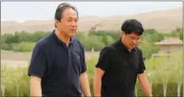  ?? ?? The two Zhangs at an excavation site; Yu Tianxiu, director of the academy’s cultural relics digitaliza­tion institute, walks with his predecesso­r, Wu Jian.