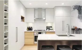  ??  ?? Kitchen design details include quartz countertop­s and porcelain tile backsplash.