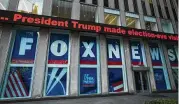  ?? MARK LENNIHAN / AP 2018 ?? A headline about President Donald Trump is displayed outside the studios of cable news giant Fox News in New York.