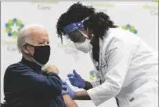  ?? CAROLYN KASTER/AP ?? PRESIDENT-ELECT JOE BIDEN receives his first dose of the coronaviru­s vaccine from nurse partitione­r Tabe Mase at Christiana Hospital in Newark Del., on Dec. 21, 2020.