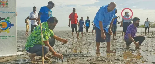  ?? Circled: Photo: Nicolette Chambers ?? The Minister for Employment, Productivi­ty and Industrial Relations and Youth and Sports, Parveen Bala and the Taukei Vidiliio, William Bouwalu planting mangroves at Namoli Village in Lautoka on October 1, 2021. Police Corporal Lavenia Bechu.