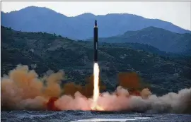  ?? KOREAN CENTRAL NEWS AGENCY / KOREA NEWS SERVICE ?? This photo distribute­d by the North Korean government shows the “Hwasong-12,” a new type of ballistic missile at an undisclose­d location in North Korea.