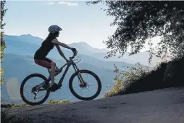  ??  ?? A mountain biker enjoys a ride in the Aspen area.