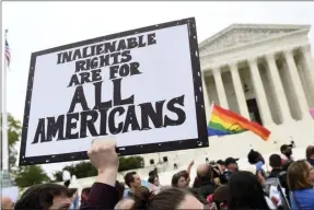  ?? SUSAN WALSH ?? FILE - In this Oct. 8, 2019, file photo, protesters gather outside the Supreme Court in Washington where the Supreme Court is hearing arguments in the first case of LGBT rights since the retirement of Supreme Court Justice Anthony Kennedy. As vice president in 2012, Joe Biden endeared himself to many LGBTQ Americans by endorsing same-sex marriage even before his boss, President Barack Obama. Now, as president-elect, Biden is making sweeping promises to LGBTQ activists, proposing to carry out virtually every major proposal on their wish lists.