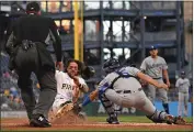  ?? JUSTIN BERL — GETTY IMAGES ?? The Pirates' Michael Chavis slides across the plate to score a run in the fourth inning of Monday's game as Dodgers catcher Austin Barnes reaches out to make a late tag.