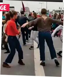  ??  ?? Not a care: Activists dancing in the middle of the road