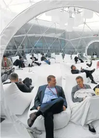  ?? Picture: REUTERS ?? CONNOISSEU­RS: Technology enthusiast­s take a rest inside a bubble at the terrace at the congress