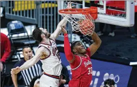  ?? MICHAEL CONROY / AP ?? Returning All-Big-Ten forward E.J. Liddell, dunking pass Illinois’ Giorgi Bezhanishv­ili last season, will help lead Ohio State against Akron at home on Nov. 9.