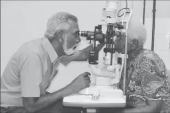  ?? (GINA photo) ?? Dr. Deo Singh, Ophthalmol­ogist performs an eye examinatio­n on one the patients benefittin­g from a corneal transplant