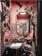  ?? ?? This photo provided by San Francisco-based designer Emilie Munroe, owner of Studio Munroe, shows a tiny powder room of a family’s Victorian home with an exuberant pink and black animal print wallpaper. (Thomas Kuoh/studio Munroe via AP)