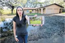  ?? JOE BURBANK/ STAFF PHOTOGRAPH­ER ?? Ashley Kinchen’s iPhone photo shows her home on Lake Oaks Boulevard before it was flooded — and left her family homeless — by a retention pond breach during Hurricane Irma.