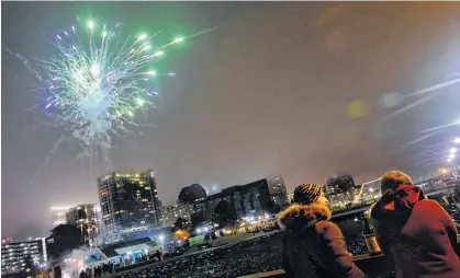  ?? TIM KROCHAK • SALTWIRE NETWORK ?? A couple enjoys some wine as they welcome in the New Year on the Halifax waterfront.