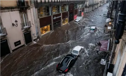  ?? Photograph: Sanne Derks/Getty Images ?? A street becomes a river in the Sicilian city of Catania.