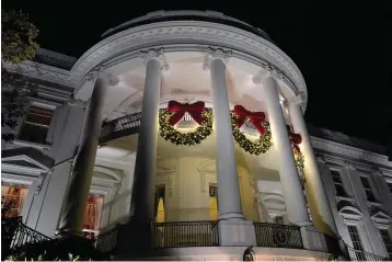  ?? The Associated Press ?? A view of the South balconies of the White House in Washington on Nov. 30, lit up with holiday decoration­s. In addition to fewer people passing through the White House for the open houses, thousands of other people didn’t get a close-up look at how Jill Biden decked out White House hallways and public rooms for the holidays because public tours of the executive mansion remain on indefinite hold due to COVID-19.