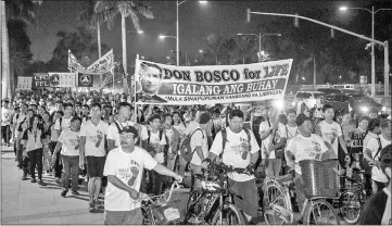  ??  ?? Catholic faithful take part in a Walk for Life’ at a park in Manila. — AFP photo