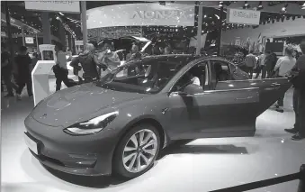  ?? -AFP ?? A Tesla Model 3 on display.