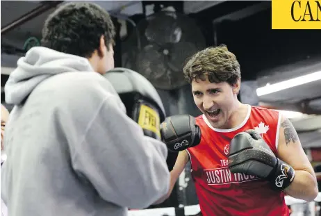  ?? SEAN KILPATRICK / THE CANADIAN PRESS ?? Prime Minister Justin Trudeau spars at Gleason’s Gym in Brooklyn, N.Y. The prime minister has mastered the attention-seeking photo-op, Michael Den Tandt writes, but the more Trudeau does this, the greater the odds he’ll eventually slip up, much to the...