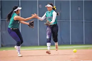  ?? MARLA BROSE/JOURNAL ?? Rio Rancho’s Brianna Gallegos, left, congratula­tes teammate Briana Martinez on an inning-ending catch during their softball win over Cleveland.