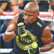  ?? JOE CAMPOREALE / USA TODAY SPORTS ?? Floyd Mayweather throws punches with weights in his hands in preparatio­n for his Aug 26 bout with Conor McGregor at T-Mobile Arena in Las Vegas.