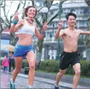  ?? XU KANGPING / FOR CHINA DAILY ?? Joggers take part in “naked pig run” in Hangzhou, Zhejiang province, in January.