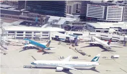  ??  ?? A Cathay Pacific Airways Airbus A330 plane is towed past other planes parked at the Sydney Internatio­nal Airport terminal in Australia, November 30, 2017. (Reuters)