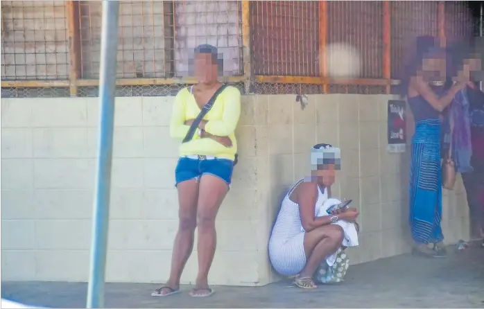  ?? Picture: FILE/ATU RASEA ?? Sex workers waiting for clients at the Suva Handicraft Centre.
