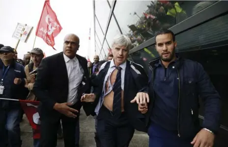  ?? KENZO TRIBOUILLA­RD/AFP/GETTY IMAGES ?? Pierre Plissonnie­r, centre, head of long-haul flights at Air France, faced chants of “naked, naked” in the latest protest to turn physical in France.