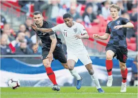  ??  ?? England’s Marcus Rashford, centre, in action against Croatia.