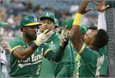  ?? DUANE BURLESON — THE ASSOCIATED PRESS ?? The A’s Starling Marte celebrates with Tony Kemp (5) after hitting a solo home run against the Detroit Tigers during the fourth inning Wednesday in Detroit.