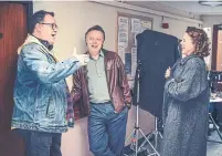  ??  ?? Russell T Davies on the set of "It's a Sin" with Shaun Dooley and Keeley Hawes, who play Ritchie's parents.