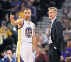  ??  ?? Stephen Curry habla con Steve Kerr, su entrenador en los Warriors.