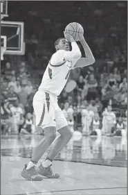  ?? Associated Press ?? Long distance: Arkansas guard Mason Jones shoots a 3-point shot against Vanderbilt during the first half of an NCAA college basketball game Tuesday in Fayettevil­le.