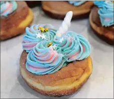  ?? DANA JENSEN/THE DAY ?? The Unicorn doughnut is made with marshmallo­w frosting, star sprinkles, a hand-rolled unicorn horn and edible glitter.