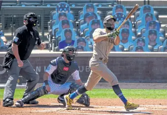  ?? Justin Edmonds, Getty Images ?? San Diego’s Eric Hosmer watches his three- run home run as Colorado catcher Drew Butera and umpire Tom Woodring look on during the first inning of Sunday afternoon’s game at Coors Field.