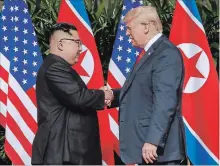  ?? EVAN VUCCI THE ASSOCIATED PRESS ?? U.S. President Donald Trump shakes hands with North Korea leader Kim Jong Un at the Capella resort on Sentosa Island Tuesday, in Singapore.