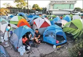  ?? Gary Coronado Los Angeles Times ?? THE HIGH COURT’S ruling on whether to exclude from the census U. S. residents in the country illegally could push the issue to the Biden administra­tion. Above, migrants await their U. S. court cases at a camp in Matamoros, Mexico.