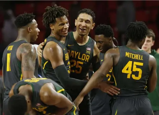  ?? Associated Press ?? Baylor’s Mark Vital, from left, Freddie Gillespie, Tristan Clark, Devonte Bandoo and Davion Mitchell celebrate after beating Oklahoma, 65-54, Tuesday in Norman, Okla., the top-ranked Bears’ 23rd win in a row, a Big 12 record. No. 3 Kansas awaits Saturday.