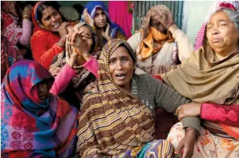  ?? AP PHOTO/ RAJESH KUMAR SINGH ?? Shanti Devi, center, mother of paramilita­ry soldier Mahesh Yadav, who was killed in Thursday’s explosion in Kashmir, mourns at her home Saturday in Tudihar, nearly 35 miles east of Prayagraj, Uttar Pradesh state, India. The death toll from a car bombing on a paramilita­ry convoy in Indian-controlled Kashmir has climbed to at least 40, becoming the single deadliest attack in the divided region’s volatile history, security officials said Friday.