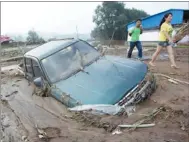  ?? ZHA JINHUI / FOR CHINA DAILY ?? A car is stuck in silt in Fushun, Liaoning province. Parts of the province were hit by heavy rain for days, and at least 316,000 people were affected.