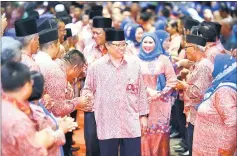  ??  ?? Abang Johari shakes hands with the PBB delegates upon his arrival at the convention centre. Walking behind him are Dr Abdul Rahman and Sharifah Hasidah. — Photo by Muhammad Rais Sanusi