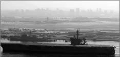  ?? BULL
AP PHOTO/GREGORY ?? In this July 9, 2020, file photo the USS Theodore Roosevelt aircraft carrier makes its way into San Diego Bay as seen from San Diego.