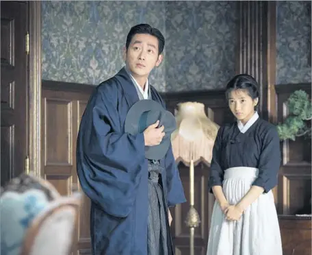  ?? TIFF ?? A CON ARTIST (Ha Jung-woo) with designs on an heiress’ fortune enlists a young pickpocket (Kim Tae-ri) in “The Handmaiden.”